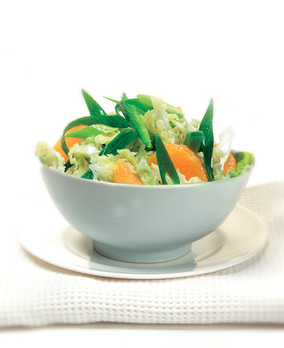 Citrus Coleslaw recipe prepared and presented in large wuite bowl on white plate.